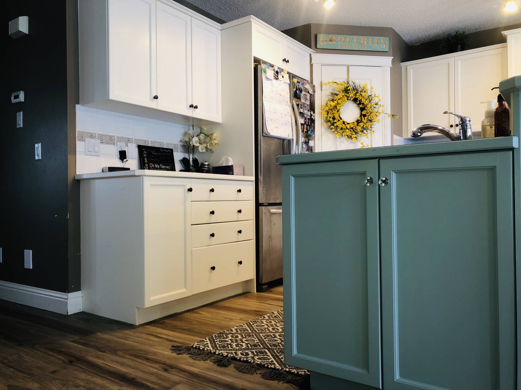 White painted cabinets with chic teal accent island