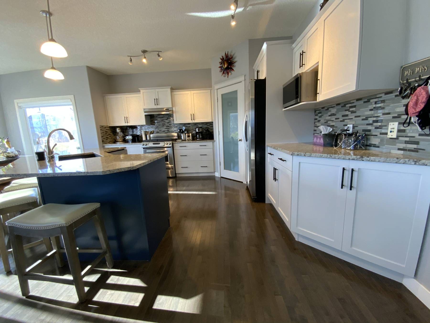 Modern two-tone white and blue painted cabinets with black hardware