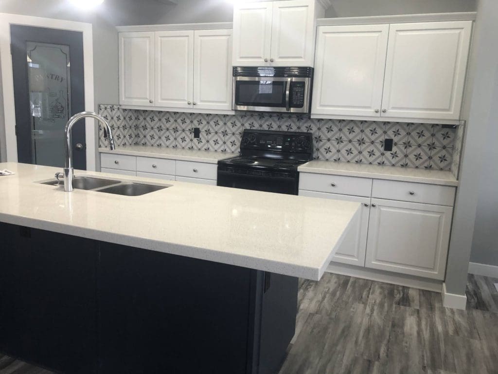 Okotoks modern two-tone white kitchen with navy accent island