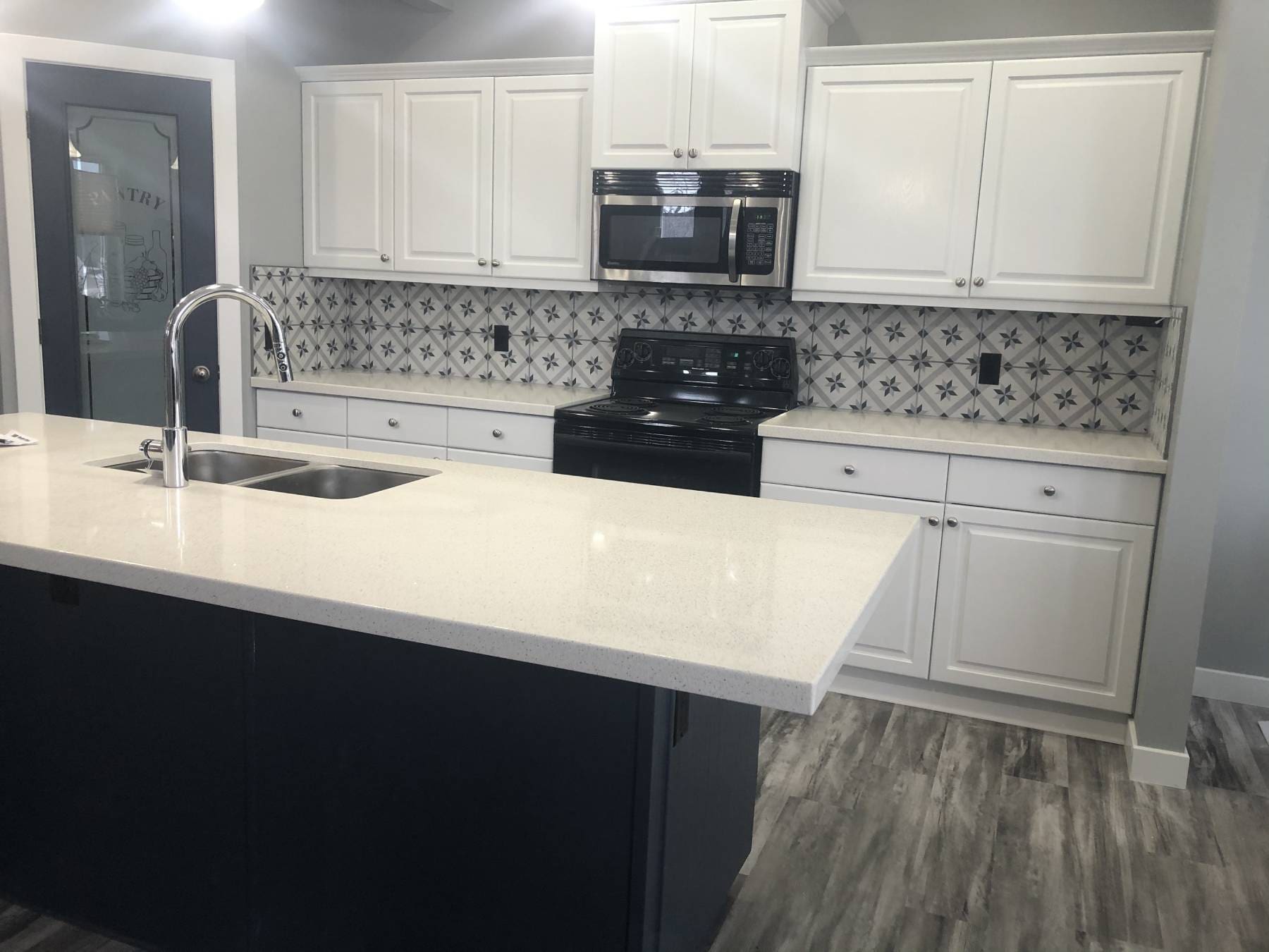 Okotoks modern two-tone white kitchen with navy accent island