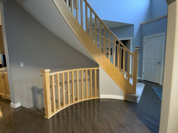 SE Calgary curved staircase yellow maple before painting