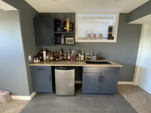 Dark navy painted basement bar