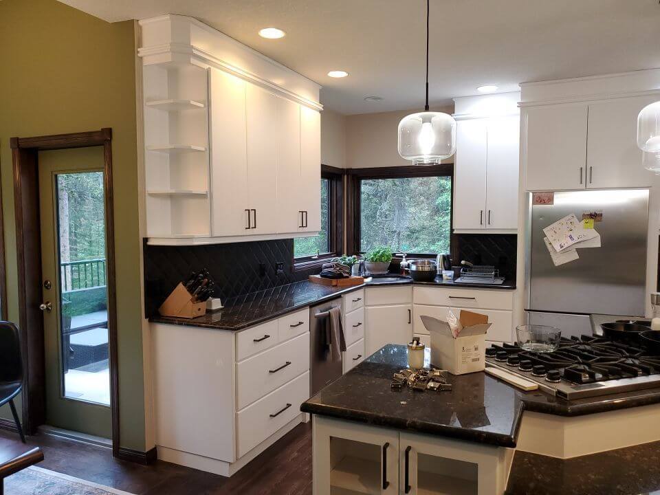Modern white painted Bragg Creek kitchen with black handles
