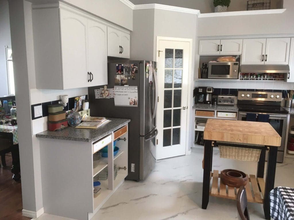 Grey painted cabinetry with grey walls and white crown trim