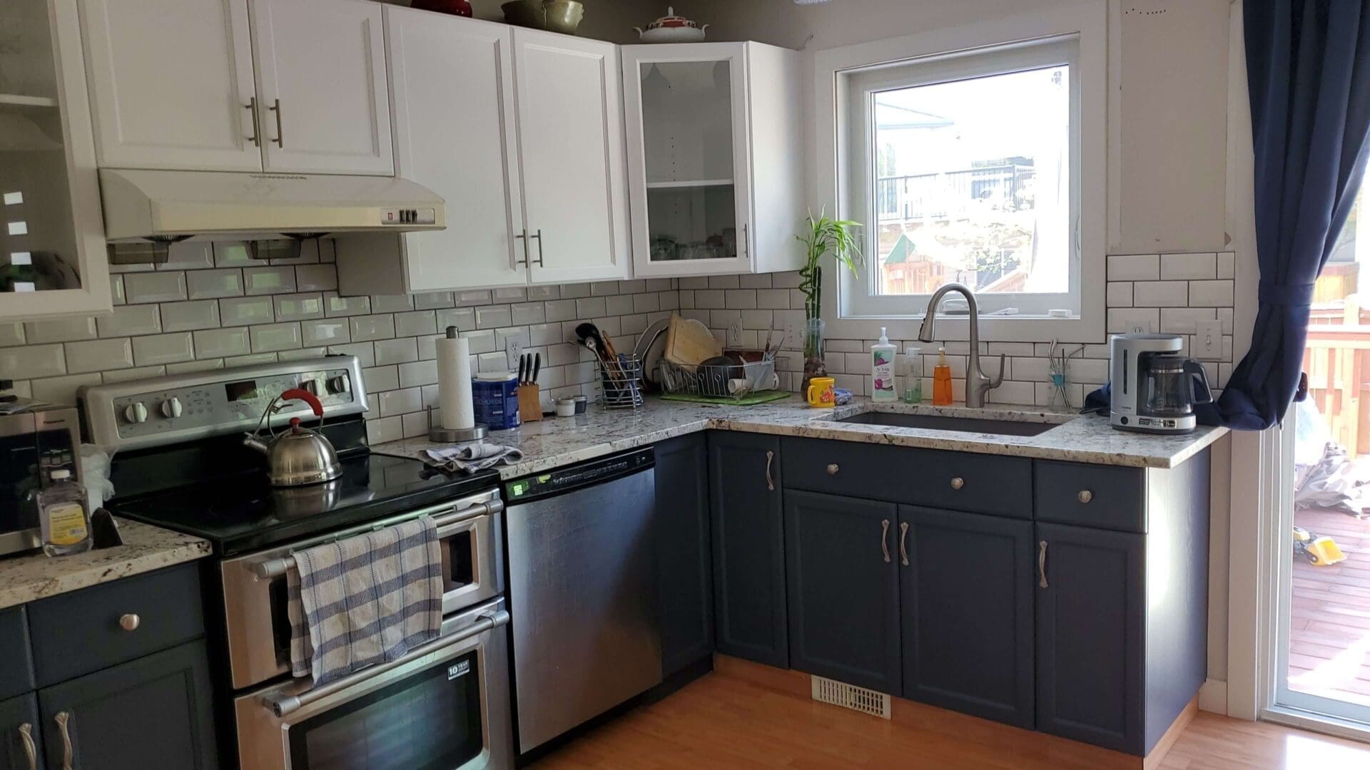 Matching white window frame white kitchen with navy accent lowers